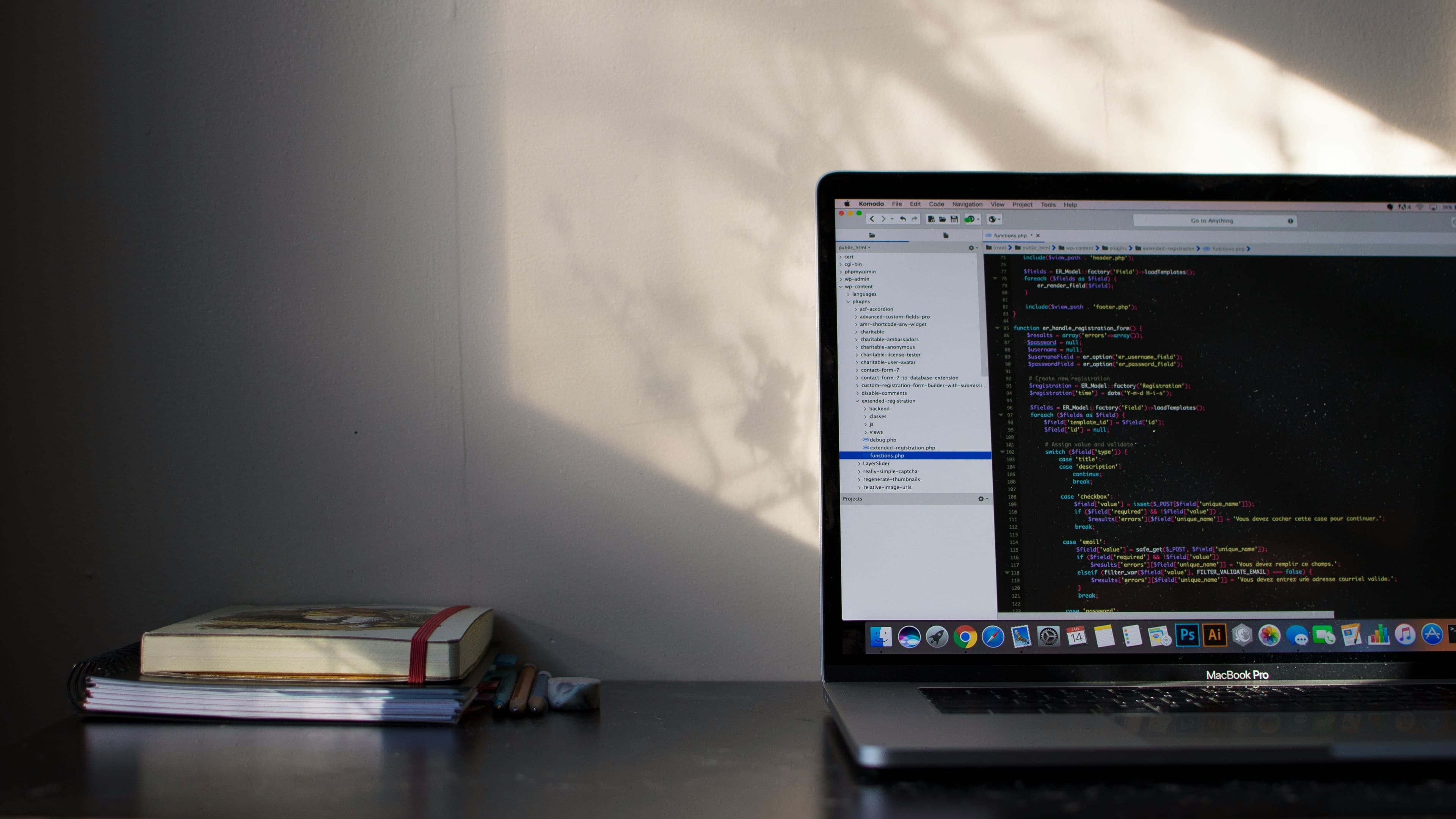 A laptop on a study desk with a code editor open
